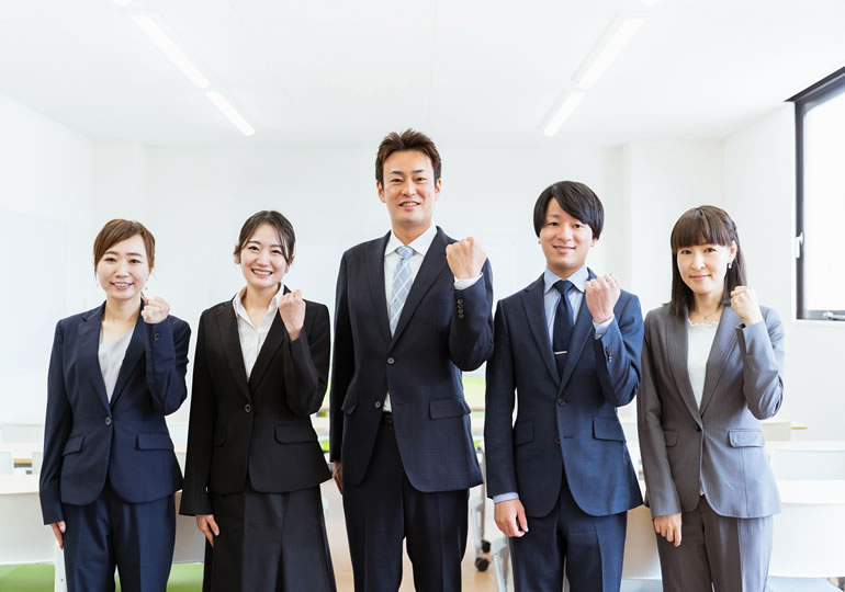 死後ビジネスのオフィスでガッツポーズをする男女のスタッフ