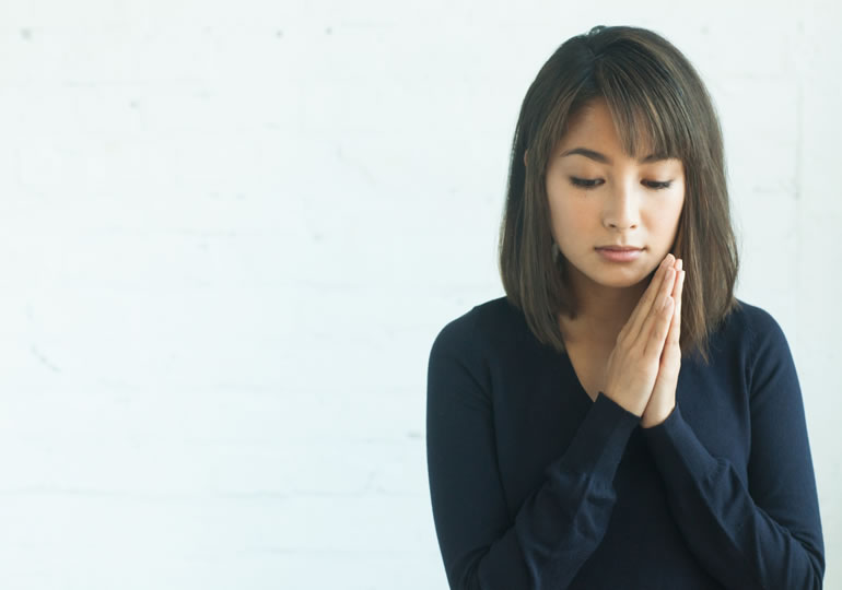 手を合わせる女性