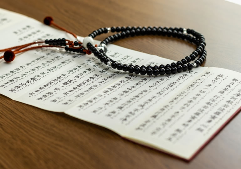 写経の上に置かれた数珠